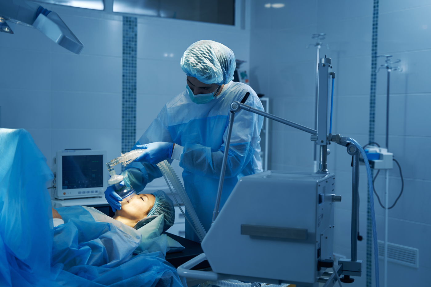 Careful anesthesiologist putting mask on the face of patient
